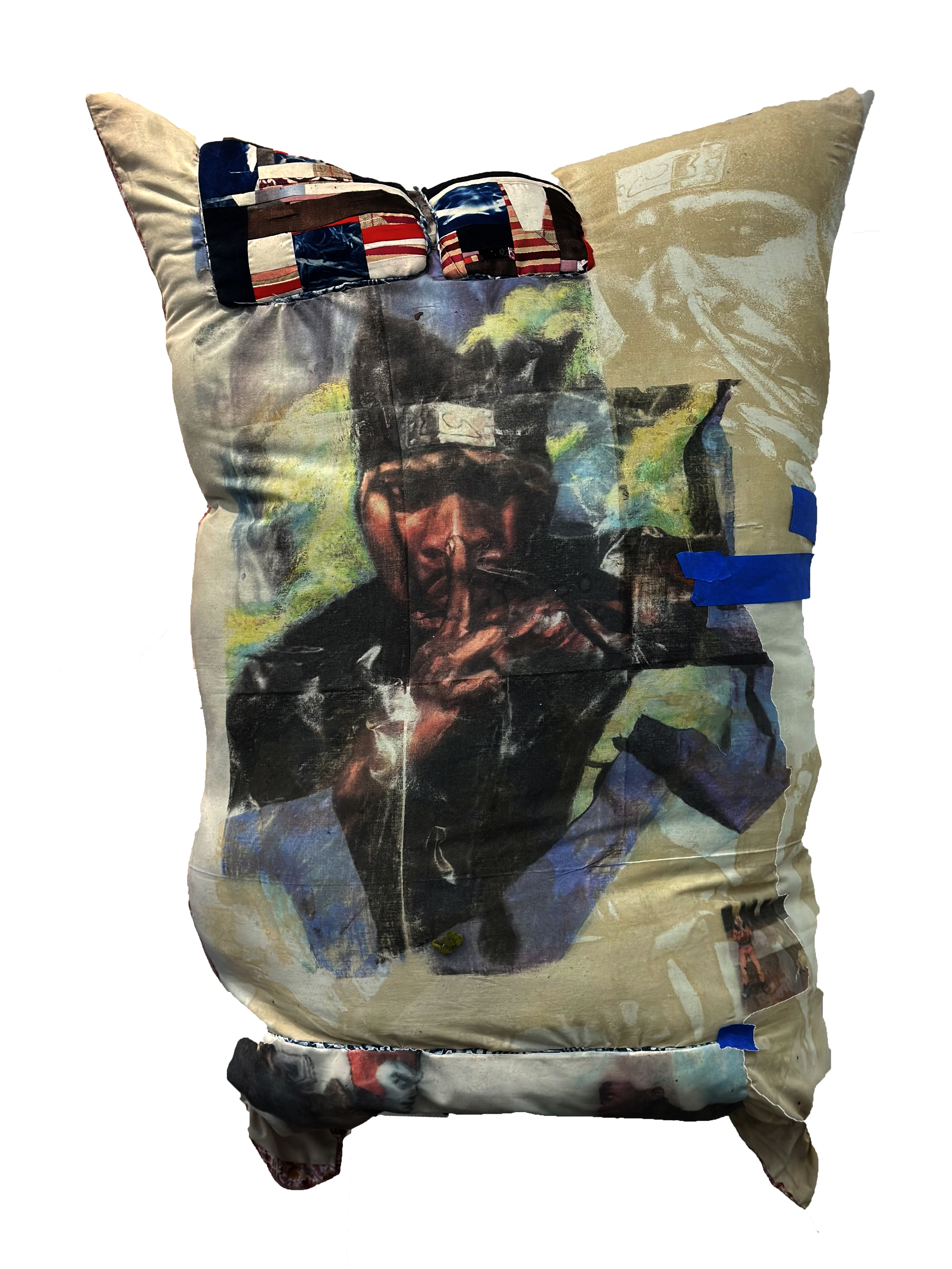 A stuffed muslin pillow featuring laser-engraved imagery of faces and figures layered with American flag patterns. Sunglasses with flag-patterned lenses sit atop the pillow, while blue tape strips and quilted patches accent the cream-colored surface, creating a mixed-media collage effect.