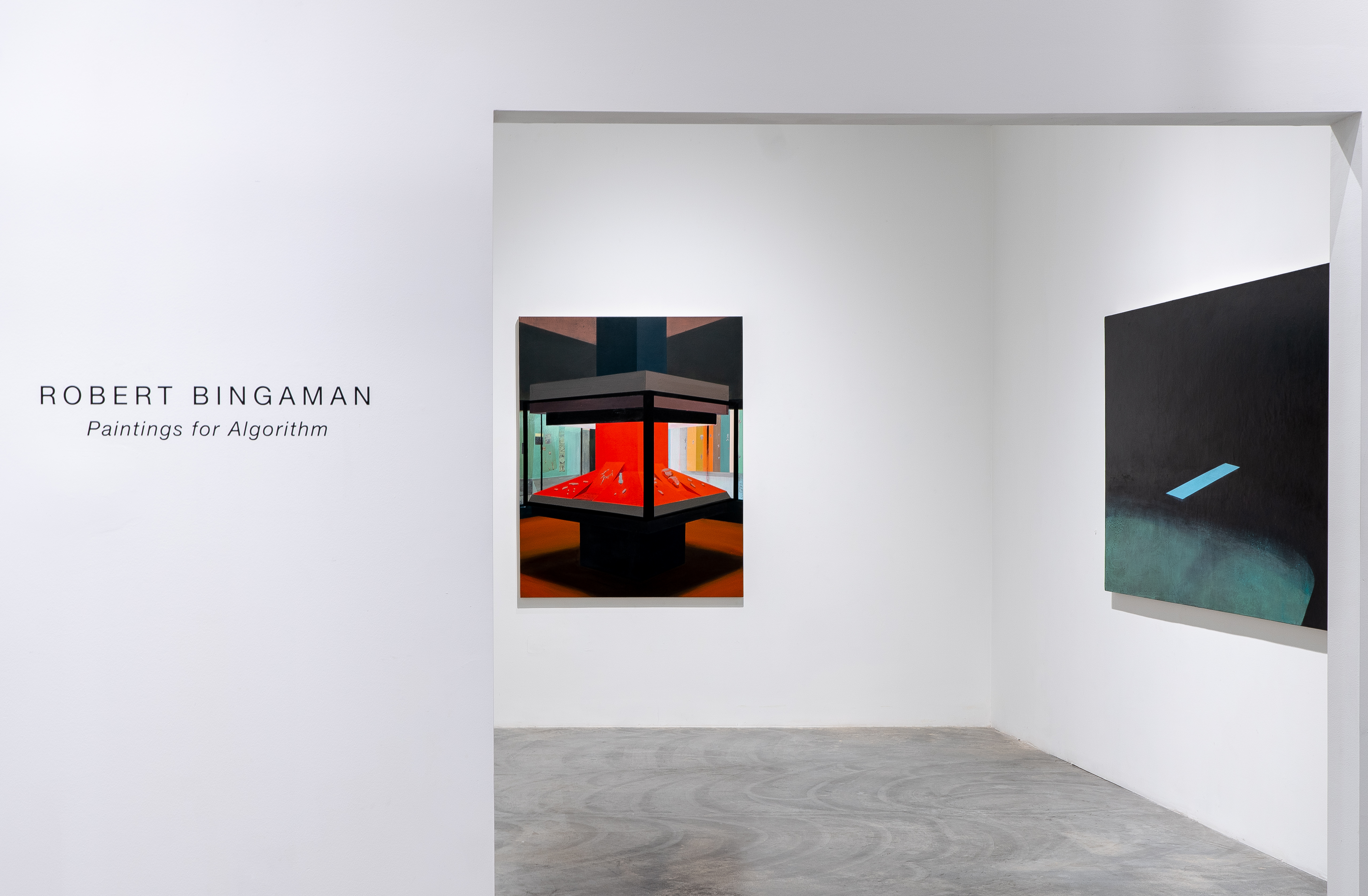 Gallery interior view displaying two paintings mounted on white walls. On the left, a geometric composition depicting an interior space with red central forms and angular black architectural elements. On the right, a minimalist dark painting with a single light blue rectangular form against a black wall and teal-toned ground. Concrete floor visible below.