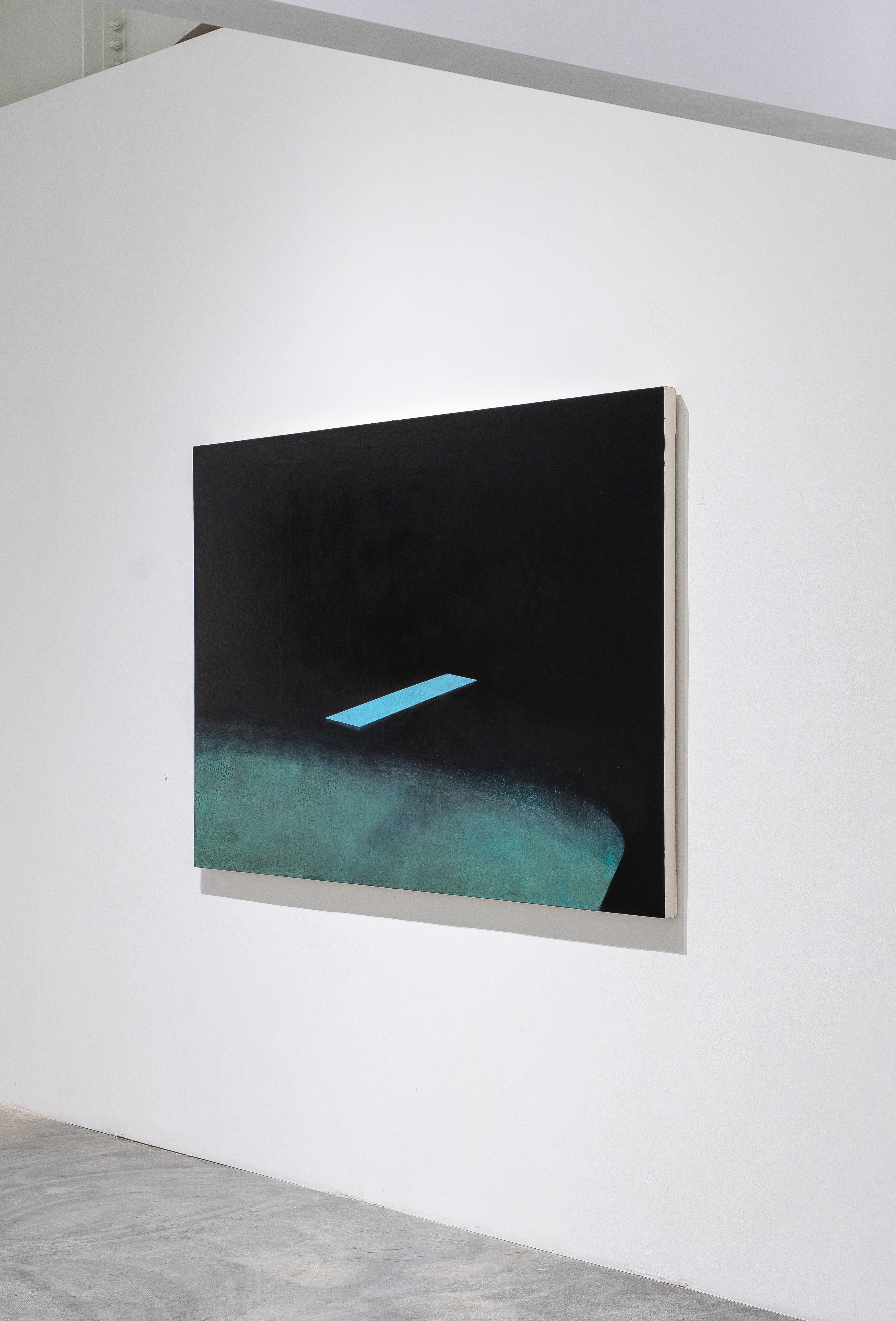Abstract composition featuring a stark black upper half with a bright blue rectangular form floating horizontally, and a textured teal-green curved shape in the lower portion against a white gallery wall, presented in a light wood frame.