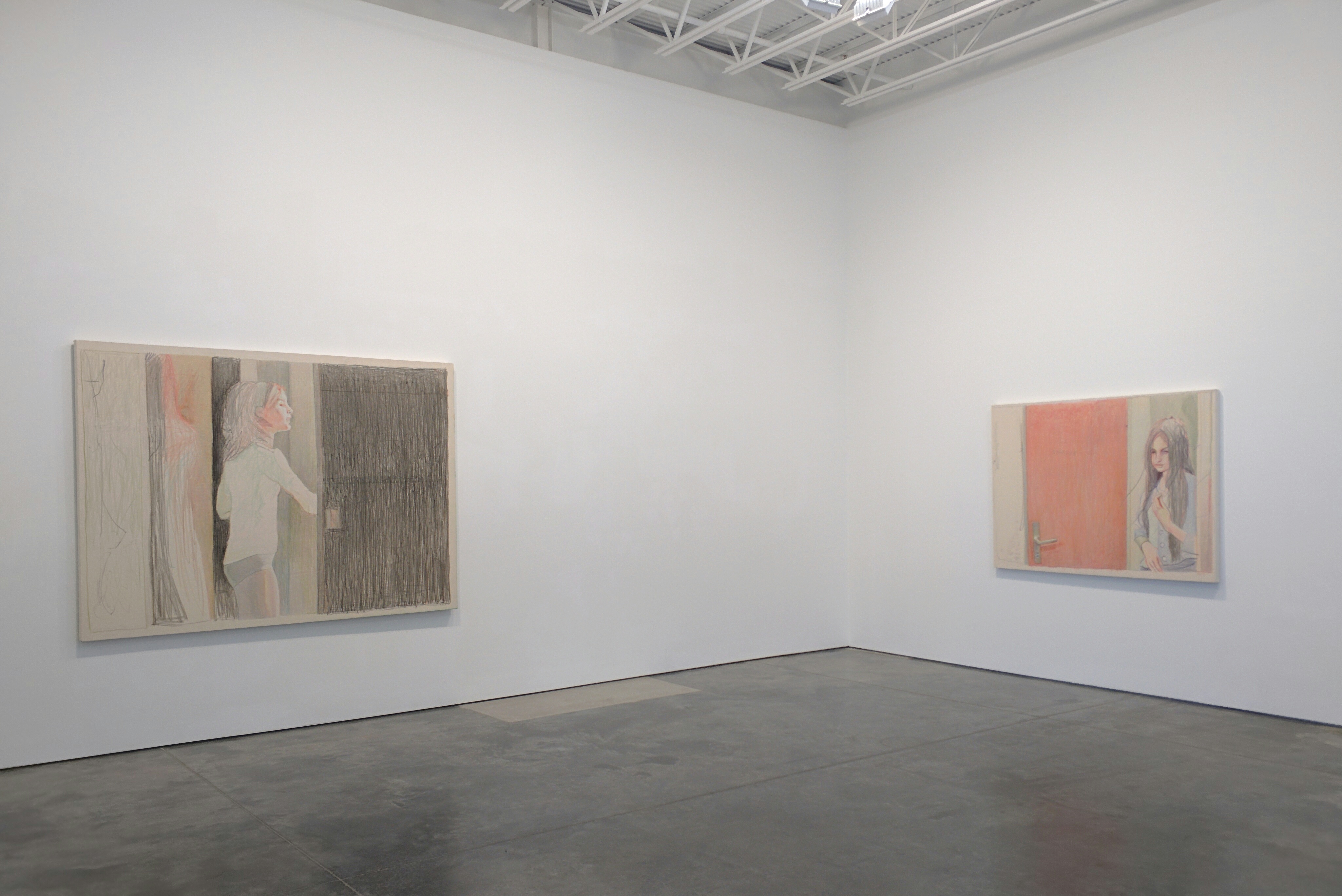 Two paintings depicting young women in interior spaces hang on white gallery walls. The larger work on the left features a figure in profile with muted earth tones and cross-hatched textures, while the smaller composition on the right shows a figure against a coral-colored background. Both works employ soft, naturalistic rendering with subtle color palettes dominated by beige, gray, and warm tones.